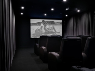 A Room With Chairs And A Screen