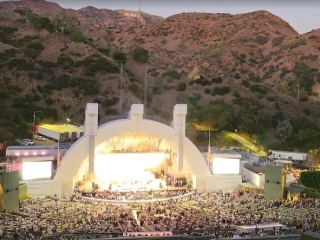 A Large Building With A Large Dome With Hollywood Bowl In The Background