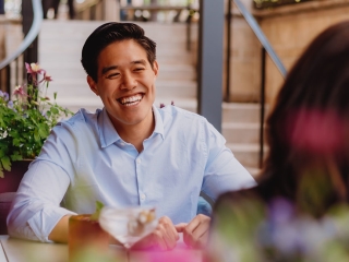 A Man Smiling At A Woman