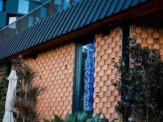 A Brick Building With A Blue Sign
