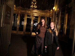 A Group Of Women Posing For A Picture In A Hallway