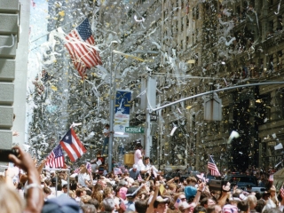 A Crowd Of People Holding Flags