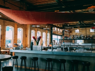 A Bar With Stools And Tables