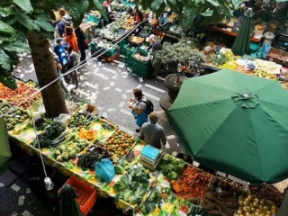 A Group Of People At A Fruit Stand