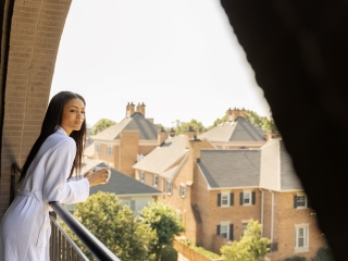 A Person Standing On A Balcony