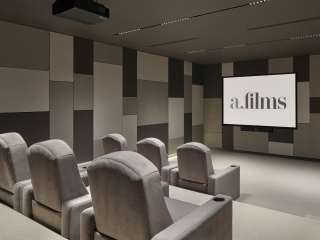 A Room With Chairs And A Screen