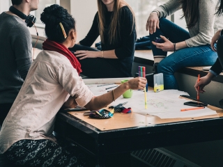 A Group Of People Around A Table