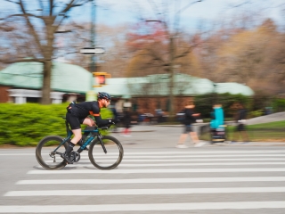 A Man Riding A Motorcycle Down A Street