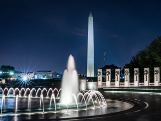 A Large Building With A Tall Tower With National World War II Memorial In The Background