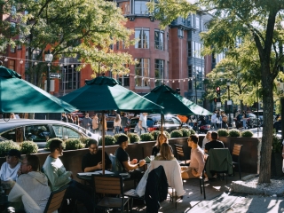 People Sitting At Tables Outside