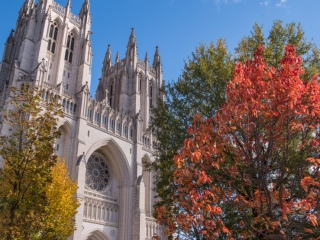 A Large Church With Trees In Front Of It With Washington National Cathedral In The Background