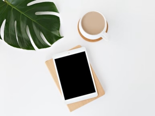 A Tablet And A Cup Of Coffee