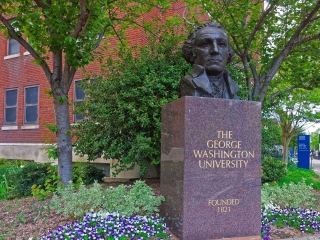 A Statue Of A Person In A Garden