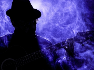A Person Playing A Guitar