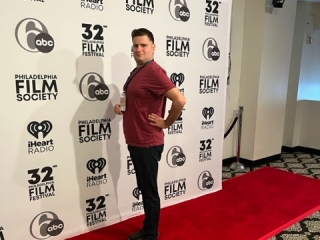 A Person Standing In Front Of A Sign