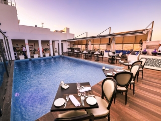A Pool With Chairs And Tables