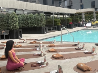 A Person Sitting At A Table In Front Of A Pool