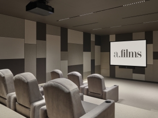A Room With Chairs And A Screen