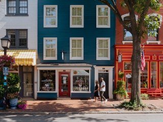 A Couple Walking On A Sidewalk