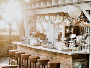 A Bar With Stools And A Chandelier