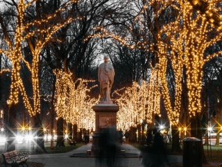 A Statue In A Park With Trees