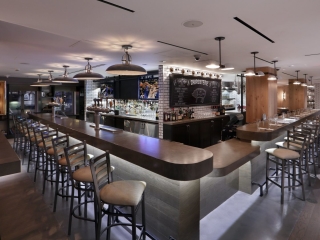 A Bar With Stools And Tables