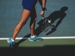 A Person Holding A Tennis Racket