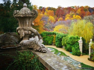 A Garden With A Fountain And Trees