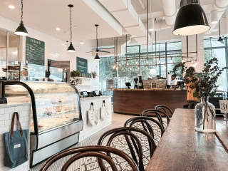 A Kitchen With A Bar And Chairs