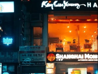 A Person Walking In Front Of A Storefront