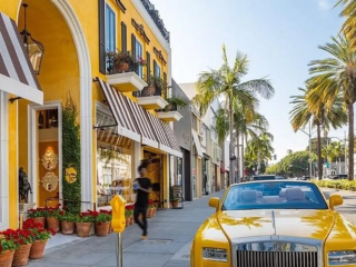 A Yellow Car Parked On The Side Of A Street