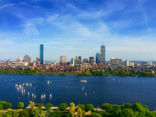 A City Skyline With A Body Of Water In Front Of It