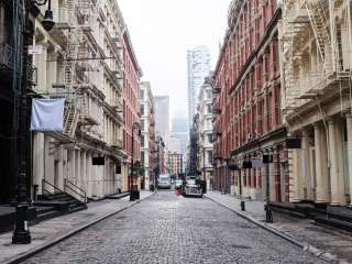 A Street With Cars And Buildings On Either Side Of It