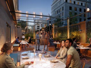 A Group Of People Sitting At Tables Outside