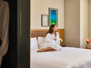 A Person Sitting On A Bed