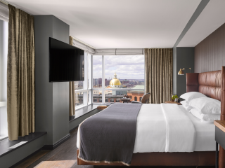 A Bedroom With A Large Window