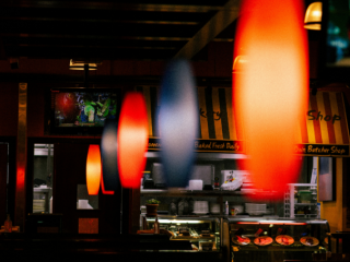 A Restaurant With A Large Neon Sign