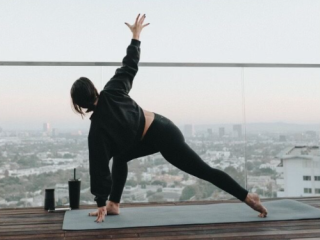 A Person Doing Yoga On A Roof