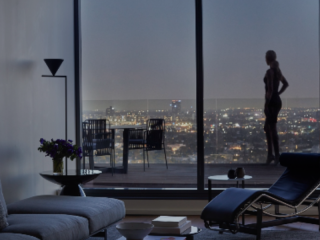 A Room With A Window And A Couch And A Table With A Chair